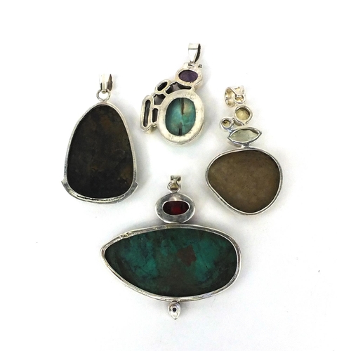 2595 - Four large silver pendants set with semi precious stones including turquoise and citrine, the larges... 