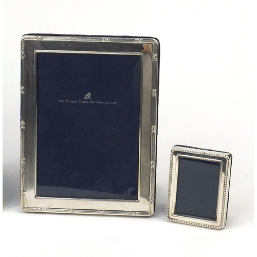 2410 - Five silver easel photo frames comprising three rectangular, an oval example and an example with flo... 