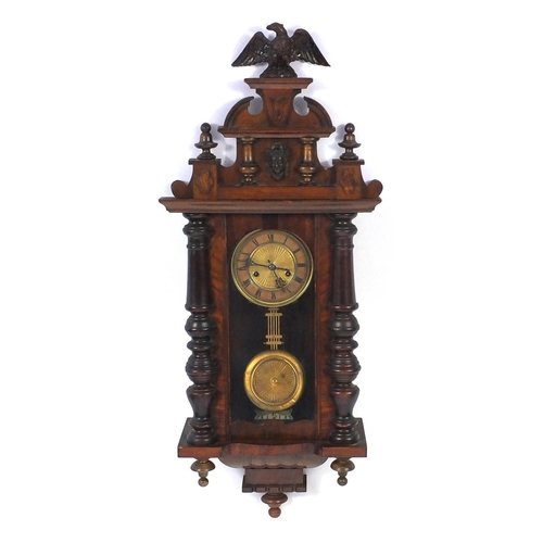 2084 - Carved walnut regulator clock with Roman numerals, decorated with an eagle, 93cm in length