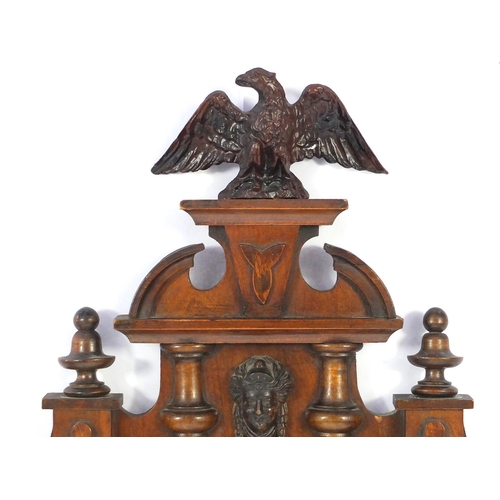 2084 - Carved walnut regulator clock with Roman numerals, decorated with an eagle, 93cm in length