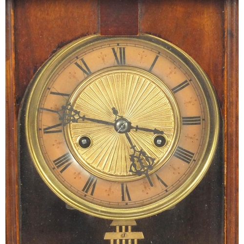 2084 - Carved walnut regulator clock with Roman numerals, decorated with an eagle, 93cm in length