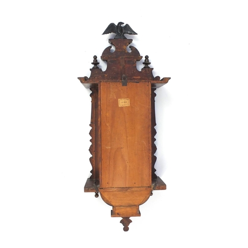 2084 - Carved walnut regulator clock with Roman numerals, decorated with an eagle, 93cm in length