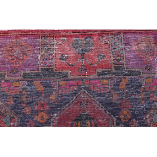2013 - Rectangular Bakhtiari rug with an all over floral design within geometric floral borders onto a red ... 
