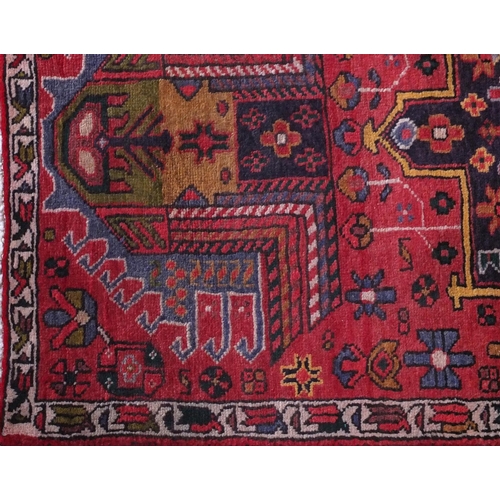 2076 - Rectangular Azarbaijan carpet runner with an all over stylised floral design onto a red ground, 320c... 