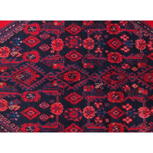 2080 - Rectangular Hamadan rug with an all over stylised floral design within two borders onto a predominan... 