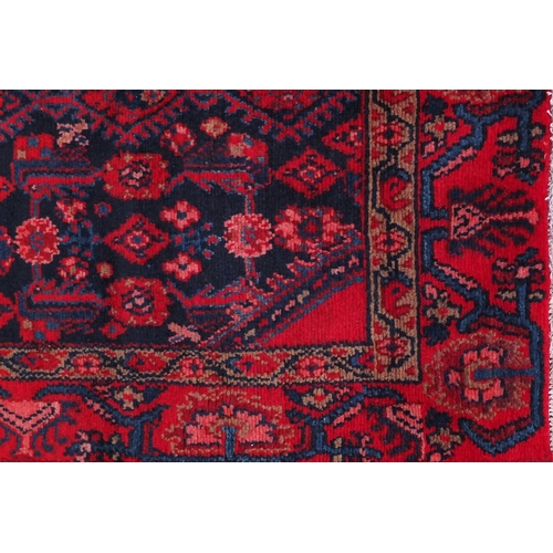 2080 - Rectangular Hamadan rug with an all over stylised floral design within two borders onto a predominan... 