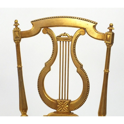 2021 - Pair of Regency gilt wooden side chairs with lyre backs and upholstered stuffover seats
