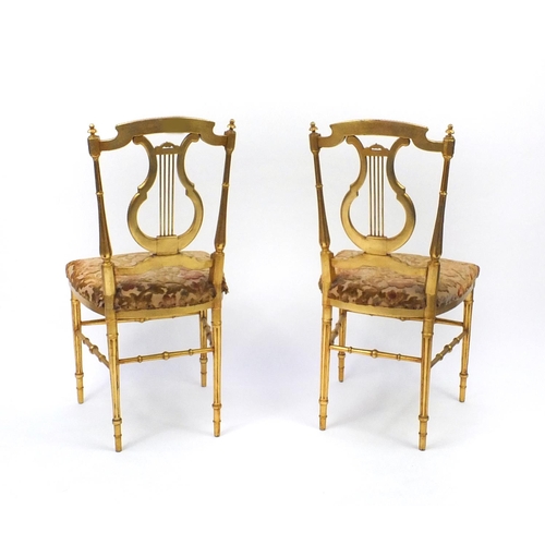 2021 - Pair of Regency gilt wooden side chairs with lyre backs and upholstered stuffover seats