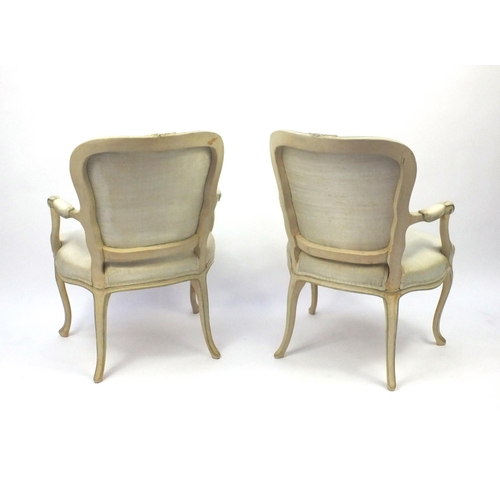 2038 - Pair of cream and green painted French fauteuil chairs with upholstered stuffover seats and back pan... 