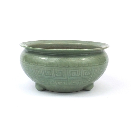 460A - Chinese celadon glazed three footed planter, decorated with stylised motifs, character marks to the ... 