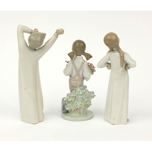 2132 - Three Lladro figures including one of a girl holding a bouquet of flowers and a bird, each with fact... 