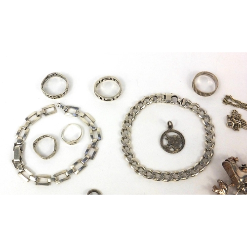 2598 - Silver and white metal including a charm bracelet with a large selection of charms, identity bracele... 