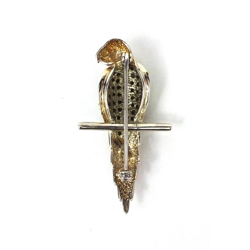 2692 - Novelty silver parrot seated on a branch brooch set with green stones, 4.6cm long, approximate weigh... 