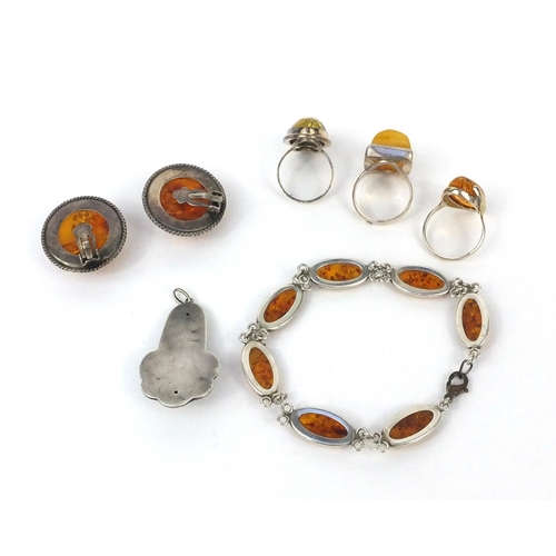 2523 - Silver and amber jewellery comprising three rings, pair of earrings, bracelet and pendant, approxima... 