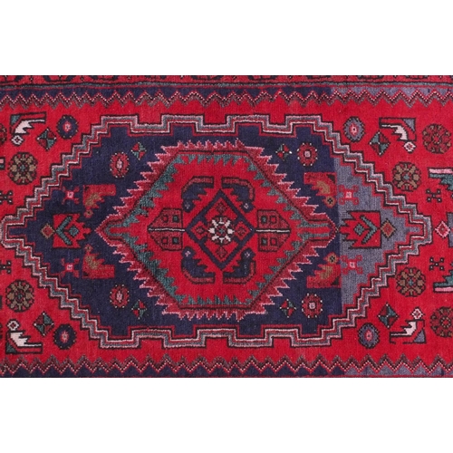 2089 - Rectangular Hamadan rug with an all over stylised geometric pattern within three borders onto a pred... 