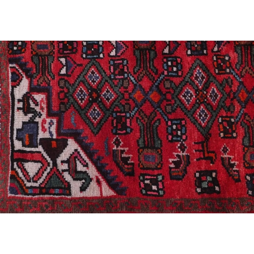 2083 - Rectangular Hamadan rug with an all over floral and animal decoration, 220cm x 133cm