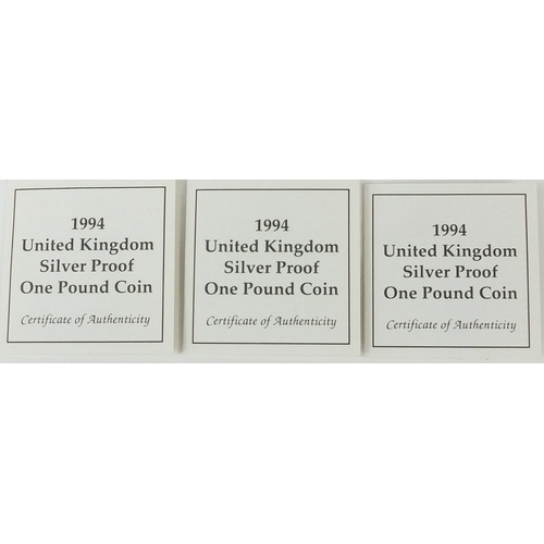 2735 - Three 1994 United Kingdom silver proof £1 coins, each with fitted cases and certificates