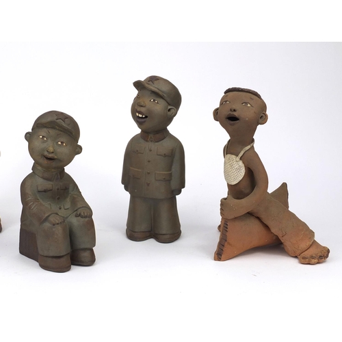 2316 - Six comical Chinese terracotta figure three in uniform, two riding a pillows and one playing an musi... 