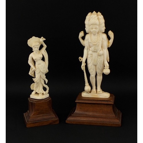 614 - Two Indian carved ivory figures, each raised on hard wood bases, the largest overall 20cm hig