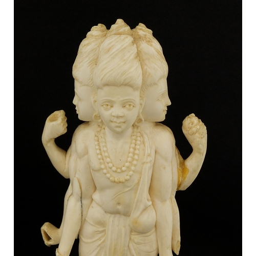 614 - Two Indian carved ivory figures, each raised on hard wood bases, the largest overall 20cm hig