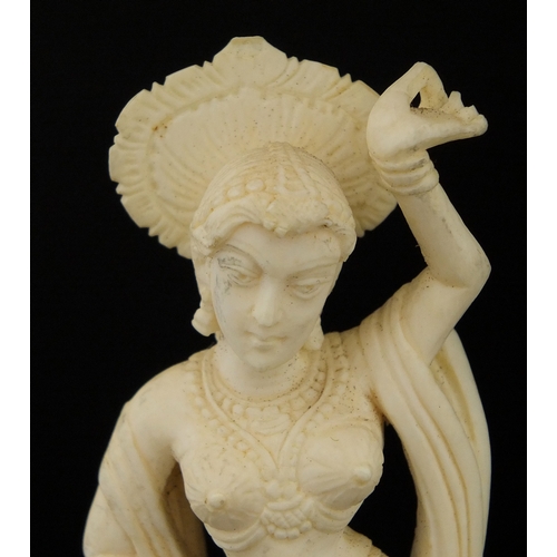 614 - Two Indian carved ivory figures, each raised on hard wood bases, the largest overall 20cm hig