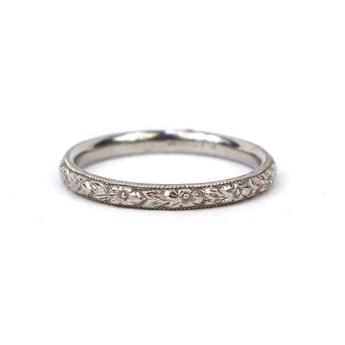 2562 - Platinum wedding band with floral moulding, size K, approximate weight 3.0g