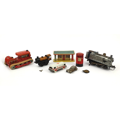 419 - Group of tinplate and clockwork toys including an orange Schuco locomotive, blue locomotive marked '... 
