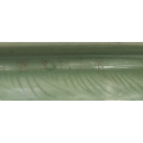 460A - Chinese celadon glazed three footed planter, decorated with stylised motifs, character marks to the ... 
