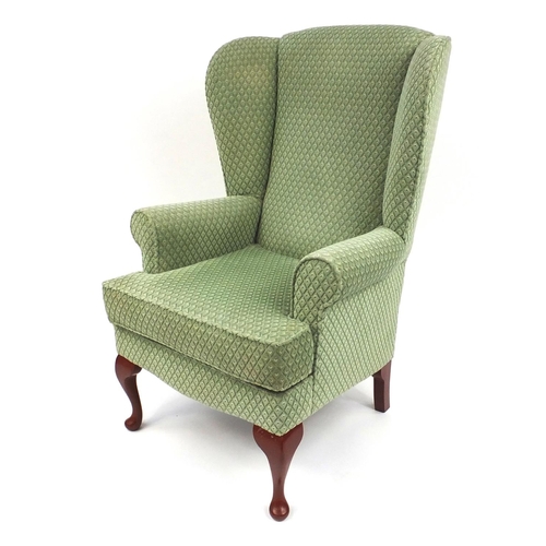 13 - Parker Knoll wing back armchair with green upholstery, 110cm high