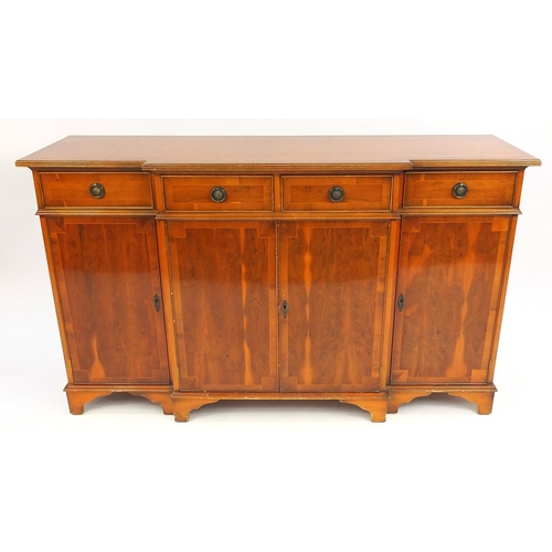 30 - Inlaid yew break front sideboard fitted with four frieze drawers above four cupboard doors, 92cm hig... 