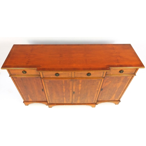 30 - Inlaid yew break front sideboard fitted with four frieze drawers above four cupboard doors, 92cm hig... 