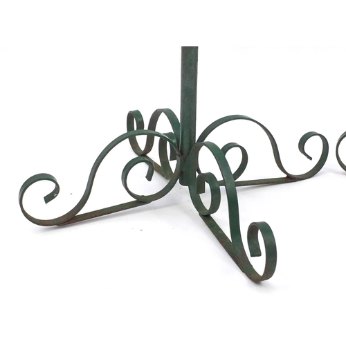 76 - Pair of wrought iron green painted planters, 62cm high