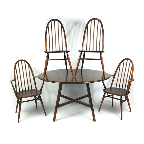 46 - Ercol drop leaf dining table and four stick back chairs including two carvers, the table 72cm high x... 