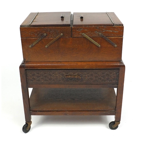 54 - 1930s oak cantilever sewing box and contents