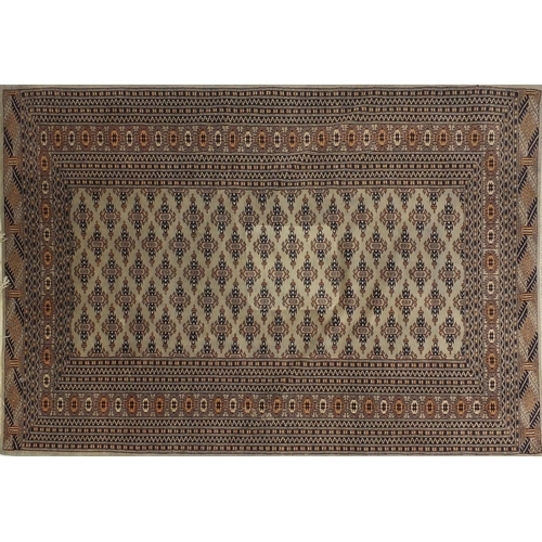 15 - Beige and blue ground geometric patterned rug, approximately 180cm x 132cm