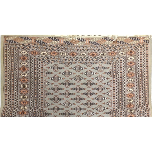 15 - Beige and blue ground geometric patterned rug, approximately 180cm x 132cm