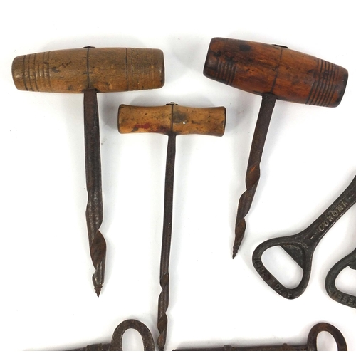 374 - Collection of antique corkscrews, bottle openers and keys