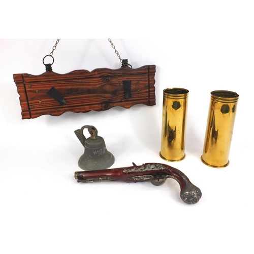 644 - Decorative percussion pistol mounted on a plaque, two brass shell cases and a decorative bell engrav... 