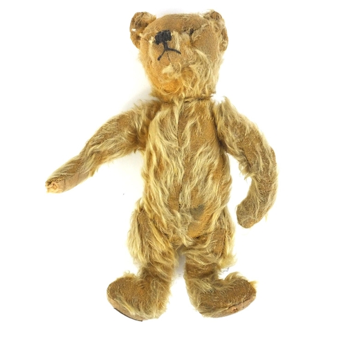 411 - Antique golden teddy bear with jointed limbs and Farnell's Alpha Toys label, 28cm high