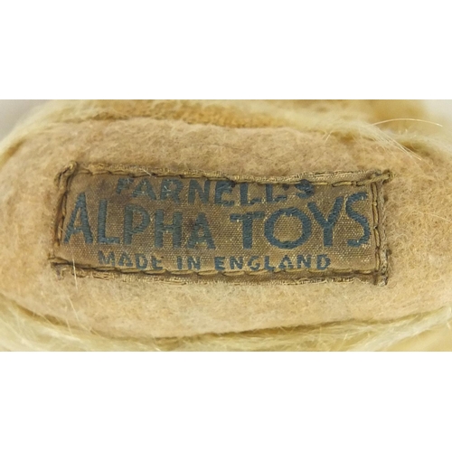 411 - Antique golden teddy bear with jointed limbs and Farnell's Alpha Toys label, 28cm high