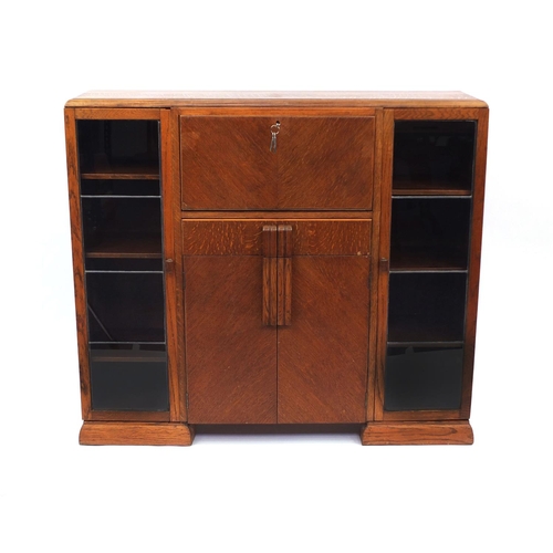 43 - Art Deco walnut cabinet fitted with a pair of glazed doors, each enclosing three adjustable shelves ... 