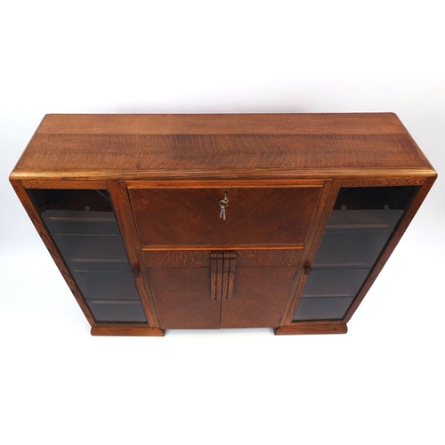 43 - Art Deco walnut cabinet fitted with a pair of glazed doors, each enclosing three adjustable shelves ... 