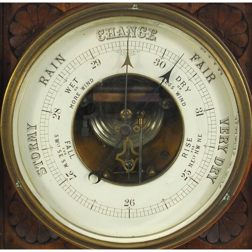 91 - Edwardian carved oak framed barometer, the dial approximately 23cm diameter