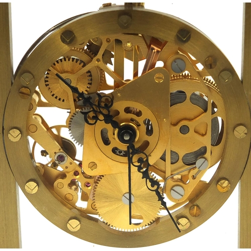 2089 - Brass cased mystery alarm mantel clock with key, 11.5cm high