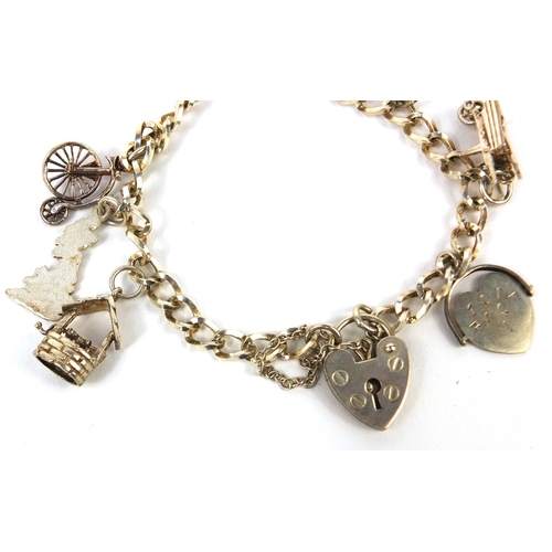 354 - Silver charm bracelet with a selection of charms including 'I Love You' spinner, approximate weight ... 