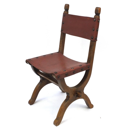 69 - Oak X framed chair with brown leather back and seat, 95cm high