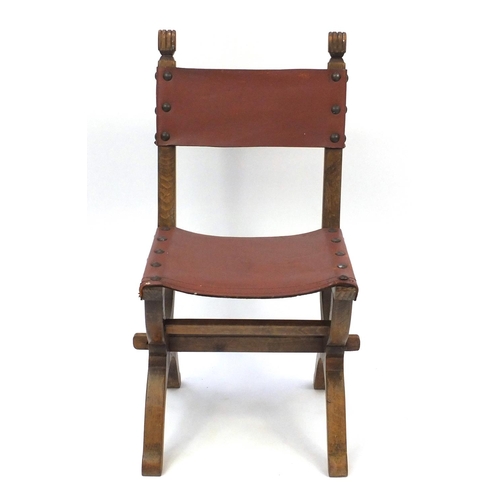 69 - Oak X framed chair with brown leather back and seat, 95cm high