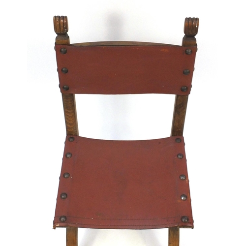 69 - Oak X framed chair with brown leather back and seat, 95cm high