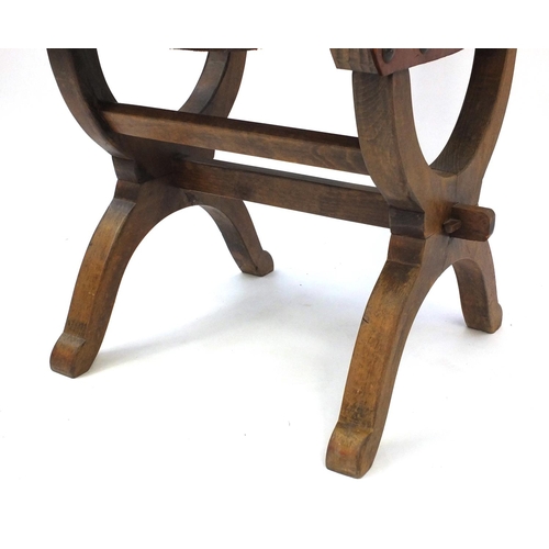 69 - Oak X framed chair with brown leather back and seat, 95cm high