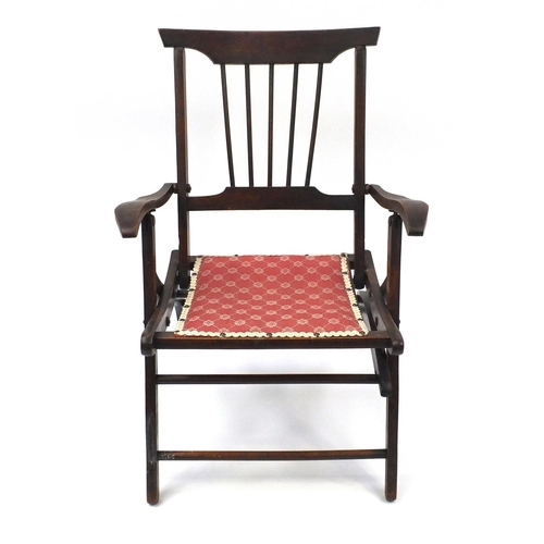 79 - Folding mahogany campaign chair with salmon upholstered seat, 80cm high